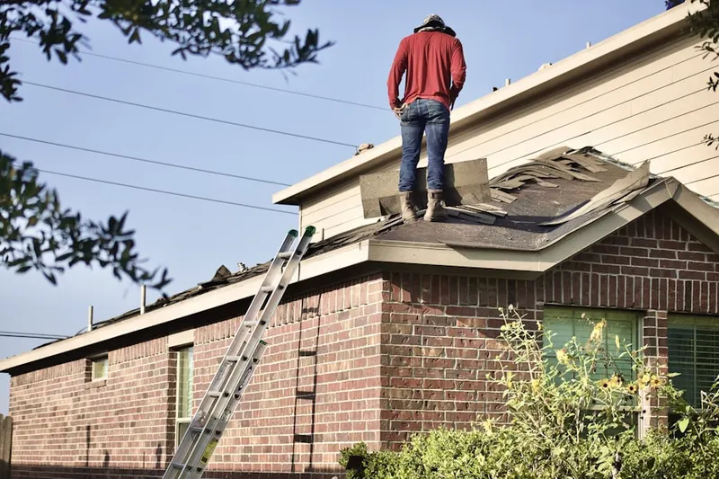 Professional roofer working on a residential roof in Eastwood Acres